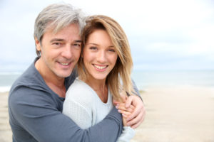 older couple smiling on the beach