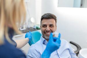 dentist showing patient a clear aligner