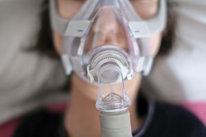 woman using CPAP machine for sleep apnea